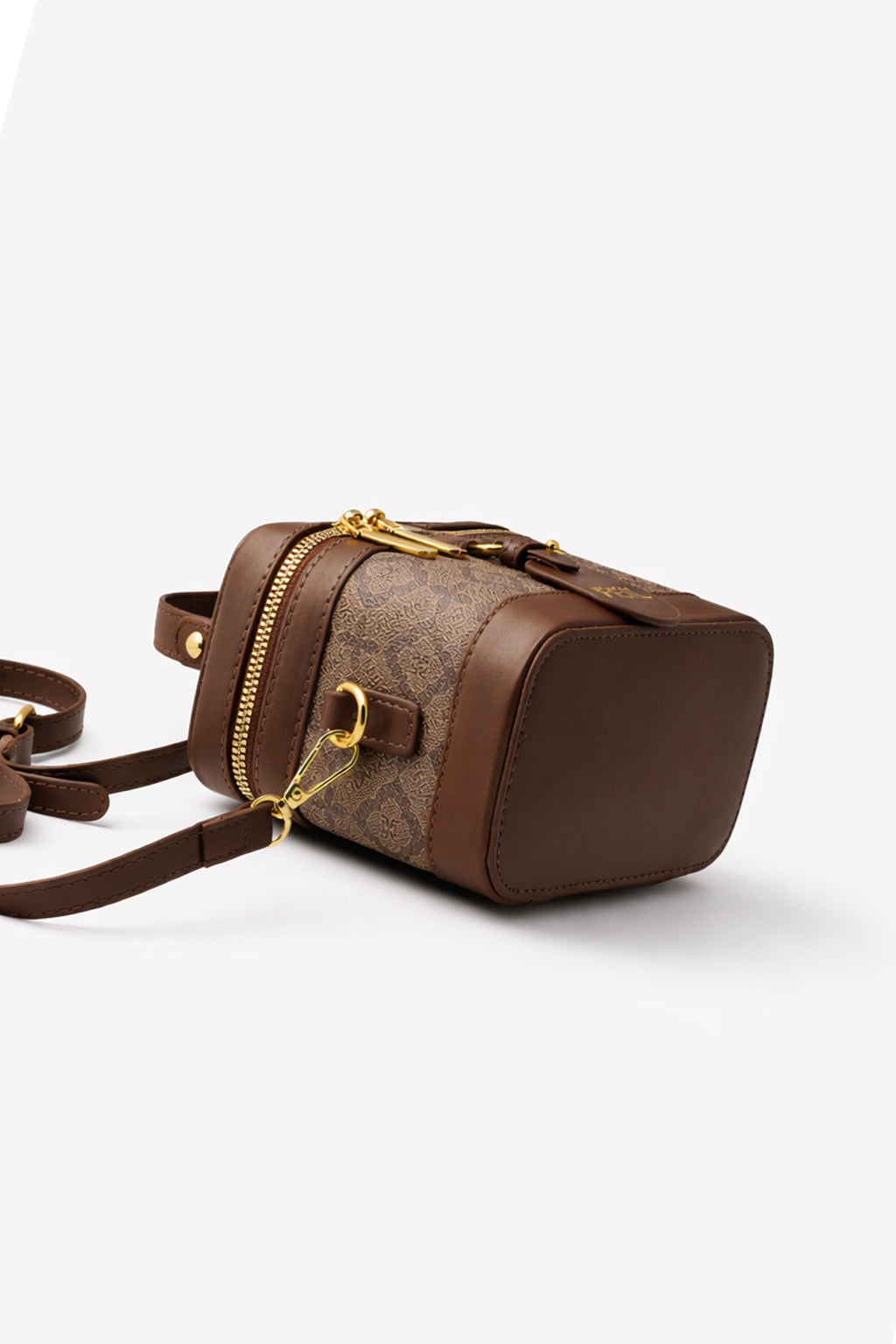 Brown handbag with gold accents on a white background