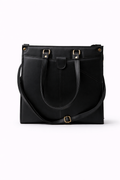 Black leather tote bag with gold hardware on a white background