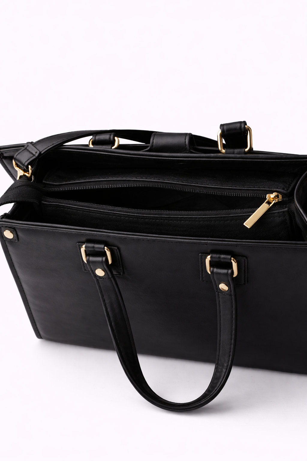 New Arrivals Black handbag with gold hardware on a white background